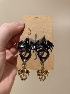 4th Wing inspired Earrings  Type A is Both gold and Black on each ear Type B is Gold on one ear Black on the other Message me when you order if you need Surgical steel hooks! Themed Black Metal Jewelry, Themed Black Jewelry As Gift, Themed Black Jewelry Gift, Black Dangle Plug Earrings As Gift, Black Dangle Plug Earrings For Gift, Nickel-free Black Plug Earrings As Gift, Black Metal Dangle Cartilage Earrings, Black Dangle Cartilage Earrings In Metal, Black Dangle Cartilage Earrings