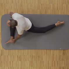 a man is doing yoga on a mat