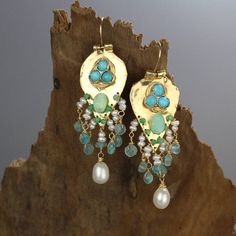 Turquoise Statement Earrings, Something Blue, Gold Filled Gemstone Earrings, Turquoise Earrings, Unique Gift for Mom, Birthstone EarringsTurquoise Sherazade earrings are made of organic gold filled shaped like a knight shield set with three natural turquoise gemstones.The earrings have a strong spiritual meaning and meant to protect its wearer.A unique setting of bezel set turquoise gemstones on the gold filled shield, and a beautiful handwoven cluster of pearls, apatite, jade and Peruvian pearl Bohemian Turquoise Earrings With Gemstone Accents, Handmade Turquoise Fusion Earrings, Turquoise Dangle Earrings For Anniversary, Green Natural Stone Earrings For Wedding, Green Natural Stones Earrings For Wedding, Turquoise Pearl Dangle Earrings, Turquoise Teardrop Pearl Drop Earrings, Bohemian Wedding Earrings With Gemstones, Turquoise Drop Earrings With Gemstone Accents