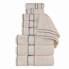 a stack of white towels with black lines on the bottom and one line down the middle