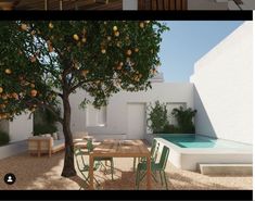 an orange tree next to a table and chairs in front of a swimming pool area