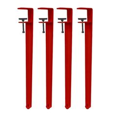 three red metal poles with two handles and one handle on each pole, all in the same