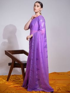 Spread the aura of freshness with this purple-heavy georgette contemporary saree showing a touch of sensuality. The amazing sequin embroidered work all over the saree. This incredible purple sequin saree comes with a matching color mono banglori blouse. This purple trendy saree is 5.50 meters long and comes with fully stitched 1.00-meter blouse material. Wear this purple sequin georgette saree to parties or any celebration to let you stand out splendidly in the crowd. Purple Pre-draped Saree With Zari Work For Celebration, Purple Georgette Pre-draped Saree For Festivals, Purple Georgette Pre-draped Saree For Eid, Elegant Purple Dupatta With Sequins, Elegant Purple Sequined Dupatta, Bollywood Style Purple Dupatta With Sequins, Bollywood Style Purple Sequined Dupatta, Traditional Purple Pre-draped Saree For Party, Festive Purple Dupatta With Sequins