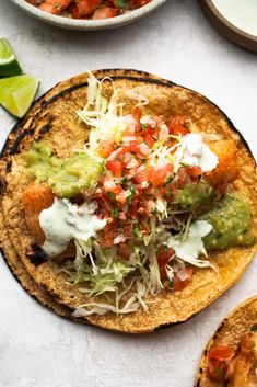 two tortillas topped with guacamole and salsa