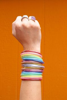 Beautiful and rainbowy, these bracelets are perfect for everything: from working on your chakras to coordinating with your favorite outfit and everything in between! ✨The Magic is in the Details✨Quantity per order: 10 BraceletsColor: Red, Orange, Yellow, Green, Aqua, Blue, Violet, Silver, Rose Gold, Yellow GoldApprox. Size: 2.75" internal diameterThese will come to you tied with a ribbon, as show in the images. As you roll on these lucky bangles, set an intention for your day, and when their spa Purple Color Outfit, Page Boy Outfits, Burgundy Flower Girl Dress, Jelly Bracelets, Glitter Rainbow, Meditation Jewelry, Lucky Colour, Burgundy Flowers, Waterproof Jewelry