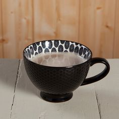 a black and white bowl filled with liquid