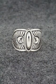 This finely crafted sterling silver ring was made by Navajo silversmith Derrick Gordon. The back is signed Derrick and stamped sterling.Size: 9.5Length: 5/8"Free shipping on all orders! We ship with USPS and always include tracking. All orders ship within a day of payment.Returns are accepted up to 30 days after you receive your order. Just send us a message. Our shop offers cash back or store credit. The item must be returned in new condition. Silver Bohemian Concho Rings, Bohemian Silver Concho Rings, Handmade Silver Western Style Rings, Handmade Western Silver Rings, Western Sterling Silver Concho Rings, Western Style Sterling Silver Concho Rings, Western Style Sterling Silver Rings In Silver, Western Style Sterling Silver Rings, Artisan Silver Ring With Concho