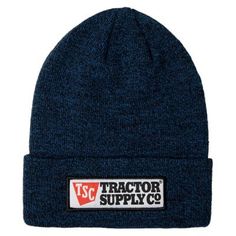 a blue beanie with the word tractor supply on it and a patch that says,