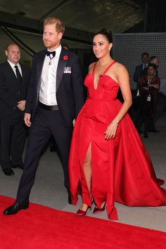 prince harry and his wife are walking down the red carpet