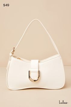 The Lulus Oh-So Chic Bone Buckle Shoulder Bag was made for every girl-on-the-go! Smooth faux leather shapes this ultra-cute handbag with a structured design and an adjustable shoulder strap. A wide strap with an oversized buckle detail and a hidden magnetic closure lifts to reveal a zippered top that opens up to a lined interior with a sidewall pouch and zippered pocket. Gold hardware throughout creates an elevated look! Lined. Bag Measures 10. 5" Wide, 6" Tall, And 2" Deep. Adjustable Between 1