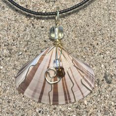 Handcrafted Wire Wrapped Seashell Beaded Pendant Necklace. Pacific Coast Seashell Neutral Cream And Brown Tones Gold Toned Wire 20” Black Cord With 2” Chain Extension Interchangeable With Other Chains Or Ribbons You May Have To Wear As A Choker Or Any Length You Prefer. Great Gift Idea Fast Shipper Host Pick Reliable Seller Made In Usa Featured @Kreativekristen In July Beach Vacation Summer Neutral Statement Necklace Unique One Of A Kind Essential Handmade Boho Shabby Chic Wedding Fashion Access Beach Shell Necklace Wire Wrapped, Beach Wire Wrapped Shell, Wire Wrapped Shell Necklace For Beach, Beige Shell Jewelry For Gifts, Beige Shell-shaped Jewelry For Gifts, Brown Beaded Shell Necklace, Seashell Jewelry, Shabby Chic Wedding, Beaded Pendant Necklace