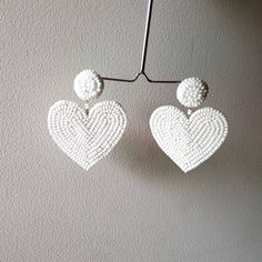 "Handmade white beaded Heart shape embroidered Earring Purely handmade seed beads embroidered heart earring looks so great. An ideal gift for bridesmaids. Earrings measure about approx. 2.10\" long and 2.10\" wide. PS: Carnation jewelry is handmade & handcrafted in India hence there is a possibility of a slight or small imperfection due to the fact that these are made by hand. I still make sure that every piece made here is perfect to look at. For more details, please see our shop policies f White Dangle Heart Bead Earrings, White Heart Bead Dangle Earrings, White Heart Beads Dangle Earrings, White Dangle Heart Earrings With Beads, White Heart Beads Earrings For Valentine's Day, White Heart Earrings With Beads For Valentine's Day, Beaded Dangle Heart Earrings For Parties, White Heart Beads Jewelry For Party, Adjustable Heart-shaped Wedding Earrings