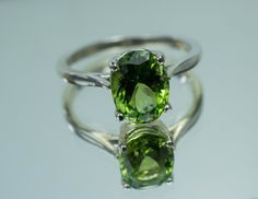 This is a beautiful Peridot from Pakistan set in Sterling Silver. This amazing stone has the perfect lime green color that many want with a great luster, and clarity!. Peridot is one of those underrated stones that has a quite remarkable history. Peridot is August's Birthstone. This nicely sized 9mm X 7mm Oval Peridot weighs 2.220cts and will go great with most styles or occasions. They will even go good with some of our Peridot Earrings located in our Gemstone Stud Earring Section. Please feel Classic Green Gemstone With Center Stone, Fine Jewelry Peridot Gemstones For Formal Occasions, Formal Green Polished Gemstones, Fine Jewelry In Green Peridot, Green Peridot Fine Jewelry, Elegant Green Peridot Gemstones, Fine Green Peridot Jewelry, Green Peridot Jewelry With Prong Setting, Oval Peridot Gemstones For Anniversary