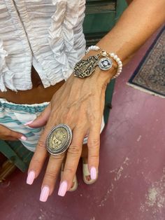 This listing is for a : Modeled by Angelia, one of our beautiful owners... A dramatic sterling and bronze Religious Inspired Sacred Heart Ring. It is adjustable  7-9.  Here at Vintage French LT we have partnered with a fabulous jewelry designer to bring our passion for France and Fashion together. Each piece is handmade with care, ensuring that no two pieces are exactly alike. Due to the nature of handmade items, the design and stones may vary slightly, adding to the uniqueness and charm of each Adjustable Metal Spiritual Jewelry, Adjustable Spiritual Metal Jewelry, Antique Hand Cast Jewelry Ring, Adjustable Spiritual Medallion Jewelry, Adjustable Silver Medallion Jewelry, Symbolic Antique Gold Medallion Jewelry, Nickel Free Bronze Jewelry, Adjustable Antique Silver Jewelry With Antique Finish, Adjustable Antique Finish Spiritual Jewelry