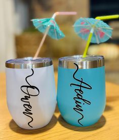 two personalized tumblers with straws and umbrellas on the top one is blue