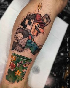 a man's leg with a mario bros tattoo on it and a trash can