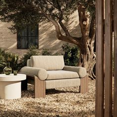 a chair and table sitting in front of a tree