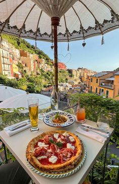 a pizza sitting on top of a table under an umbrella