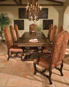 a dining room table with chairs and a chandelier