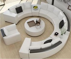 a living room filled with white furniture on top of a hard wood floor