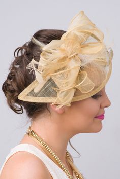 Timeless glamour. This sassy fascinator gives a nod to vintage style with a bouncy mesh ribbon and flighty feathers. With its classic sinamay mesh shape and elegant look it will be your go-to fascinator for the season. - Light weight - Attached to headband for easy wear - Comes in 18 bold colors Gold Fascinator, Hat Fascinator, Gold Hats, Fascinator Headband, Mesh Hat, Mesh Ribbon, Fascinator Hats, Champagne Gold, Easy Wear