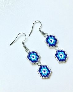 - Silver stainless steel seed beads handmade blue evil eye hook earrings - Earrings length is 4.5 cm (1.8 inches) - Miyuki seed beads, stainless steel - Colors may appear slightly different on screen due to differences in resolution, brightness, and contrast JEWELRY CARE - Keep jewelry dry - Take it off before taking shower, bath, swimming or exercising - Makeup, perfume, hairspray apply before wearing jewelry - Store your jewelry somewhere dry, not in the bathroom Handmade in Cyprus PACKING All Evil Eye Seed Bead Earrings, Handmade Blue Beaded Metal Earrings, Blue Metal Beaded Earrings For Gift, Handmade Minimalist Beaded Dangle Earrings, Minimalist Handmade Beaded Dangle Earrings, Handmade Metal Beaded Drop Earrings, Handmade Turquoise Beaded Metal Earrings, Handmade Turquoise Beaded Earrings, Blue Earrings With Spacer Beads For Gift