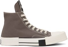 High-top canvas sneakers in gray. · Square rubber cap toe · Lace-up closure · Logo patch at extended tongue · Logo patch and eyelet vents at inner side · Rubberized logo patch at heel counter · Logo printed at padded footbed · Treaded rubber sole · Contrast stitching in white Part of the Rick Owens Drkshdw x Converse collaboration. Supplier color: Dust Drkshdw Outfit, Converse Collaboration, Gray Converse, The Rick, Grey Converse, Color Dust, Sport Shoes Men, Rick Owens Drkshdw, Chuck 70