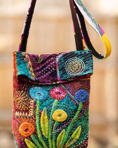 a colorful purse hanging from a hook