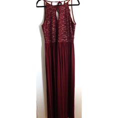 This stunning maroon evening dress from Morgan & Co is a showstopper. Perfect for any holiday or cocktail party, this sleeveless maxi dress will make you feel like a classic beauty. The dress features a solid pattern and a ball gown style, giving you a regal and elegant look. Made for women in size 14, this dress is a must-have for any wardrobe. The long dress length adds to the sophistication of the gown, making it a perfect choice for formal events. The dress comes in a beautiful shade of red that is sure to turn heads. Don't miss out on the chance to own this gorgeous dress.Size 14Pit to Pit: 18Length: 61"Waist: 16" Holiday Gala Floor-length Maxi Dress, Glamorous Sleeveless Maxi Dress For Formal Events, Glamorous Sleeveless Maxi Dress For Formal Occasions, Floor-length Maxi Dress For Gala And Holiday, Sleeveless Maxi Dress For Formal Parties, Burgundy Sleeveless Maxi Dress For Prom, Floor-length Sleeveless Dress For Prom Season, Holiday Gala Maxi Dress, Sleeveless Floor-length Dress For Prom Season