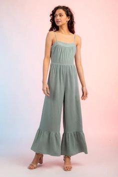 Effortlessly chic and versatile, our Sage Ruffle Hem Jumper Jumpsuit is a must-have for any fashion-forward woman. With its flattering ruffle hem and comfortable fit, this jumpsuit is perfect for any occasion. Dress it up with heels for a night out or pair it with sneakers for a casual look. Casual Solid Color Strapless Jumpsuit For Spring, Casual Strapless Jumpsuit In Solid Color For Spring, Spring Brunch Overalls Jumpsuits And Rompers, Casual Solid Color Jumpsuits And Rompers For Brunch, Casual Summer Jumpsuits And Rompers With Ruffles, Spring Brunch Overalls And Jumpsuits, Trendy Ruffled Jumpsuits And Rompers For Day Out, Spring Brunch Overalls, Casual Sleeveless Jumpsuits And Rompers With Ruffles