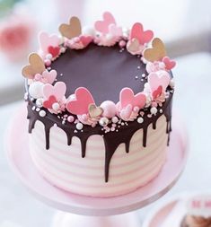 a chocolate cake decorated with hearts and flowers