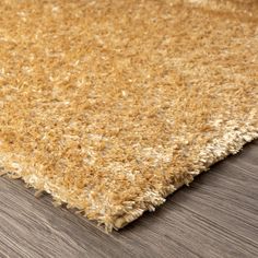 a close up view of a rug with wood flooring on the bottom and side