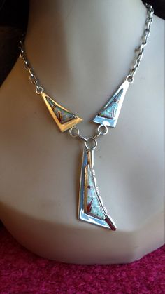 "A gorgeous Native American sterling silver inlaid opal and red jasper necklace measuring 21\" long. The center drop measures 2 1/2\" long and 3/4\" at its widest point. The chain has good weight and can be adjusted. The artist marking is above the sterling stamp. The total weight is 41.1 grams. A great look for that special occasion." Unique Gold Necklace With Inlay, Southwestern Silver Necklaces With Inlay, Silver Pendant Necklace With Inlay, Unique Adjustable Stamped 925 Necklace, Unique Adjustable Necklace Stamped 925, Unique Opal Necklaces For Formal Occasions, Southwestern Sterling Silver Inlay Necklaces, Southwestern Sterling Silver Necklace With Inlay, Southwestern Stamped 925 Necklaces For Collectors