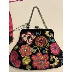 This Stunning Black Evening Bag From Vera Bradley Is A Must-Have For Any Formal Occasion. With A Beautiful Floral Pattern And Intricate Beaded And Embroidered Accents, This Limited Edition Purse Is A True Work Of Art. The Kiss Lock Closure And Silver Chain Strap Add A Touch Of Elegance, While The Microfiber Exterior And Pink Lining Make It Both Stylish And Functional. Perfect For Weddings, Parties, Or Any Special Event, This Small Pouch Is Sure To Turn Heads. Comes With Original Dust Bag. Please Multicolor Embroidered Evening Clutch Bag, Evening Multicolor Embroidered Bag, Silver Embellished Bags For Events, Multicolor Embroidered Party Bag, Evening Bag With Multicolor Embroidery, Rectangular Shape, Rectangular Evening Bag With Multicolor Embroidery, Evening Bag With Multicolor Embroidery, Rectangular Bag With Multicolor Embroidery For Evening, Rectangular Multicolor Embroidered Evening Bag