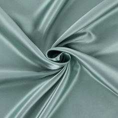 a close up shot of a green satin fabric