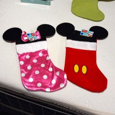 mickey and minnie mouse christmas stockings on a bed