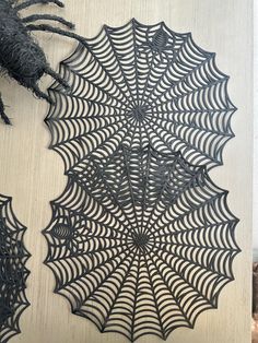 an intricate spider web is hanging on the wall