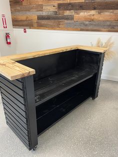 a bench made out of pallet wood and metal with storage drawers on each side