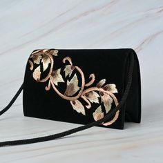 This beautifully stone studded Black Velvet Thread Work Handbag in velvet fabric fits for all occasions and attires. The handcrafted bag with intricate zardozi work and onyx stone makes it a best fit for all your formal and casual outings. The metal string makes it long lasting and the interior of this handbag is made with satin fabric and it has enough room to carry essentials and more.. This beautifully embroidered Clutch Purse is hand crafted using zardozi technique. Zardozi work is done carefully stitching layer upon layer of threads and metal wires and embellished with precious or semi precious gemstones making each piece one of its kind. Size cm : 20X12X05 Utility : Shoulder Bag Material: Velvet Fabric, Metal Thread Stones : Onyx Base Colours Available : Black Pockets: Single Care : Traditional Black Shoulder Bag For Formal Occasions, Traditional Black Formal Bag, Traditional Black Formal Shoulder Bag, Traditional Black Shoulder Bag For Evenings, Traditional Black Shoulder Bag For Evening, Traditional Black Evening Bag, Festive Black Rectangular Evening Bag, Embroidered Velvet Evening Bag, Festive Embroidered Black Bag