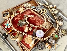 A richly curious, and loaded vintage assemblage necklace, this lovely piece is the result of culling a great number of vintage pieces including earrings, buttons, charms, and antique collectibles.  Most of the components have underlying dark or brass tones, making it a rich collection closely gathered to be a feast for the eye.  Some notable items of interest: - an 1800's tintype that I set in a bezel - a luminescent glass antique button - a watchmakers key - a lovely large round gold earring drop with rhinestones - a ladies vintage watch case in which I placed an antique black glass diminutive button - a cream colored etched celluloid button with filigree trim...early 1900's - an add-on striped bar to a military pin I work with antique and vintage parts. Some may show signs of wear or age Vintage Assemblage Necklace, Military Pins, Vintage Assemblage, Assemblage Necklace, Assemblage Jewelry, Statement Choker, Antique Buttons, Button Jewelry, Gold Earring