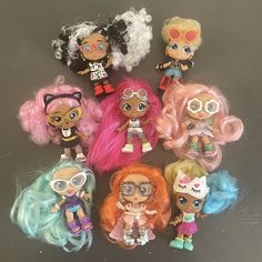 a group of little dolls sitting next to each other on top of a black surface