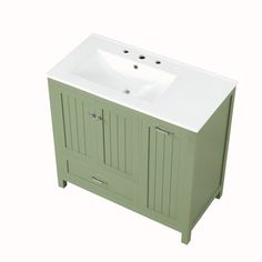 a white sink sitting next to a green cabinet with drawers on it's sides