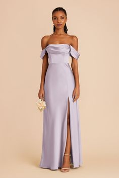 a woman in a lavender colored dress with an off the shoulder top and thigh slit