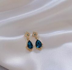 Our beautiful Gold & Blue drop earrings would make beautiful wedding or prom earrings The drop is 2.5cm The width and length of the blue gem is 1cm Check out our mix and match any 4 items of your choice for £30!  In every listing there is a mix and match photo with a number unique to that item, when purchasing the mix and match listing please quote the 4 unique item numbers so I know which items you would like sending.  If the listing has different colours or styles please also specify this with Water Earrings, Earrings Prom, Nails Elegant, Dainty Gold Earrings, Blue Drop Earrings, Dangle Earrings Gold, Drop Earrings Gold, Prom Earrings, Deep Winter