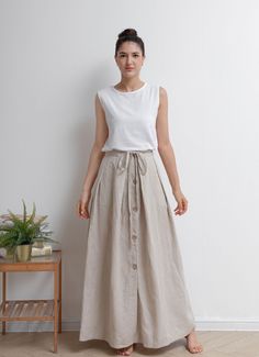 "Drawstring single breasted linen skirt made of natural linen fabric, front button closure, split hem, you can pair with everything you own in summer. ★★FEATURES 100% Linen Front button closure Waist with adjustable drawstring Front split skirt A Line skirt Casual skirt Perfect for Summer, Spring, Autumn ★★ Model Size Height approx 162 cm (5′ 4″) Bust 84 cm (33\") Waist 66 cm (26\") She wears size XS. ★★ Bespoke Order Service If you Request other color Request the length Your height is not betwe Cream Linen Skirt Outfit, Lenin Skirt, Linen Maxi Skirt Outfit, Casual Midi Skirt Outfit, Cottage Skirt, Linen Skirt Outfit, Cotton Skirt Outfit, Custom Skirt, Linen Skirts