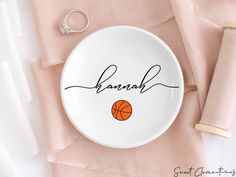 a white plate with a basketball on it and the word hannah written in cursive writing