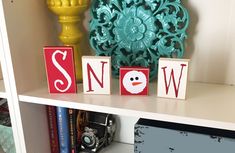 a shelf with some wooden blocks that spell out the word snow