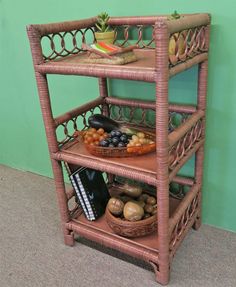 a wicker shelf with fruit and vegetables on it