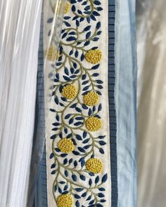 a blue and white ribbon with yellow flowers on it