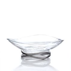 a clear glass bowl with two twisted handles